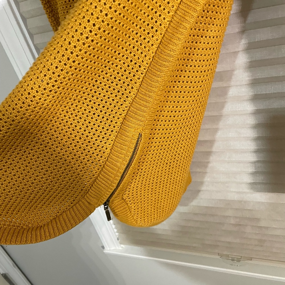 Long sweater. Perfect with leggings and has zipper detail on the side